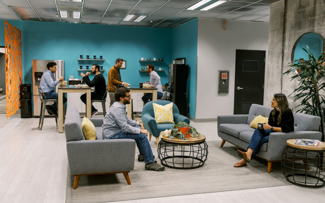 Coworkers networking in coLAB lounge