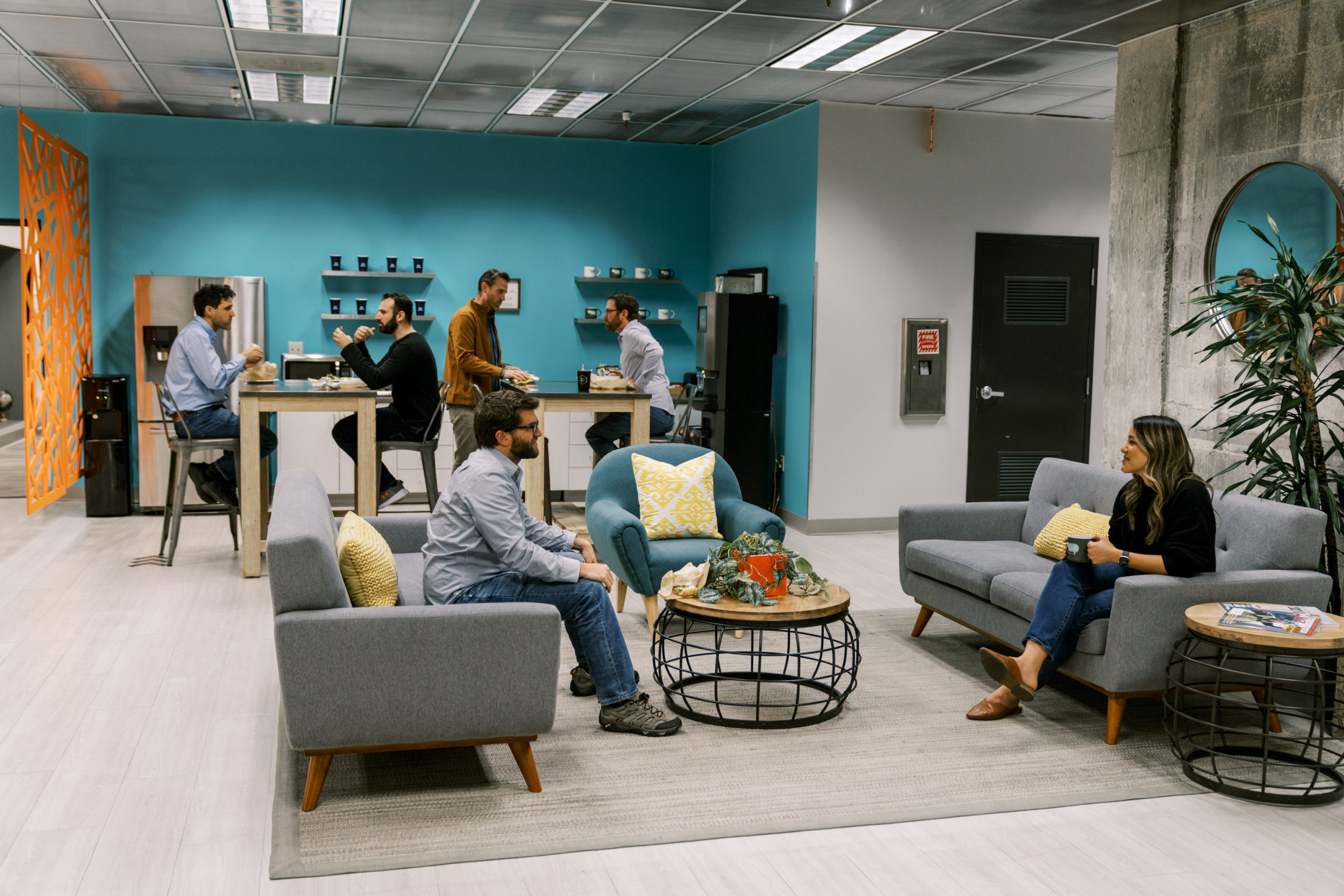 Coworkers networking in coLAB lounge