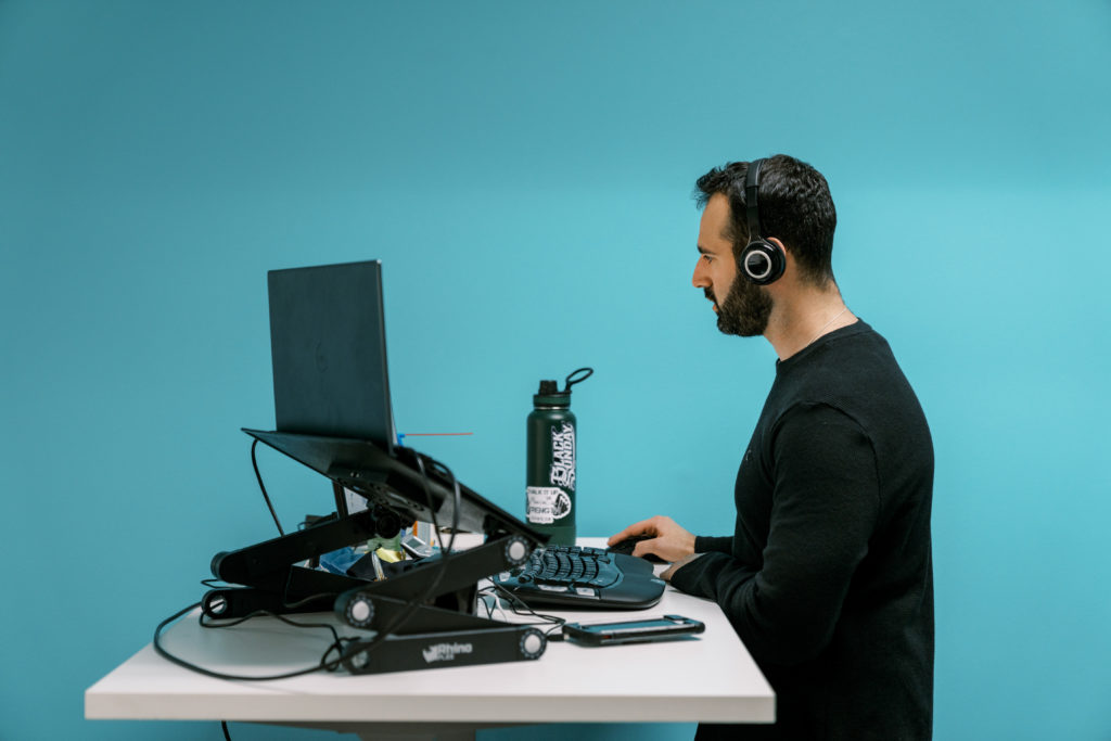 coLAB member working at their desk, listening to music.